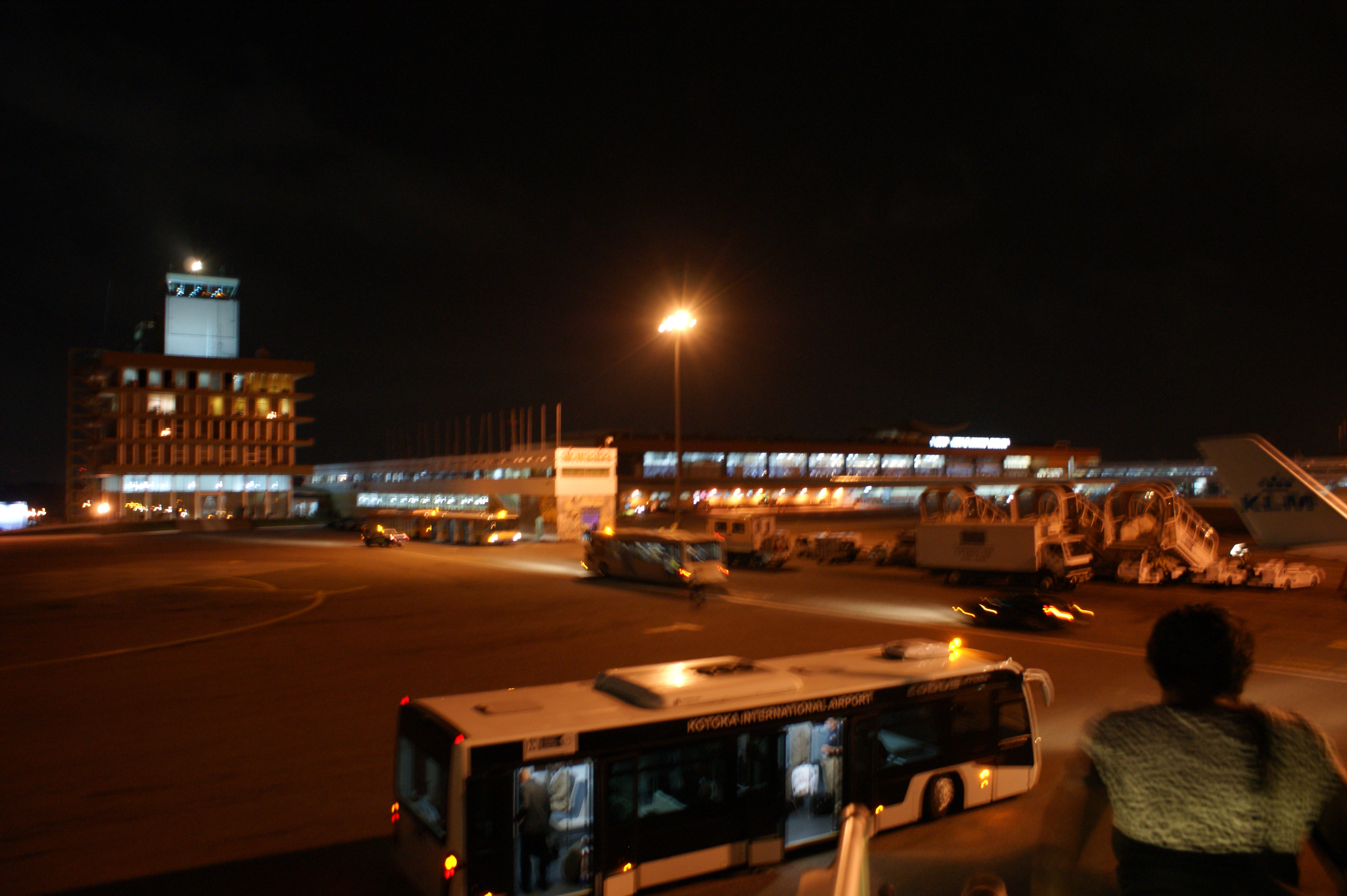 Passengers leaving an aircraft at night at the old Accra airport