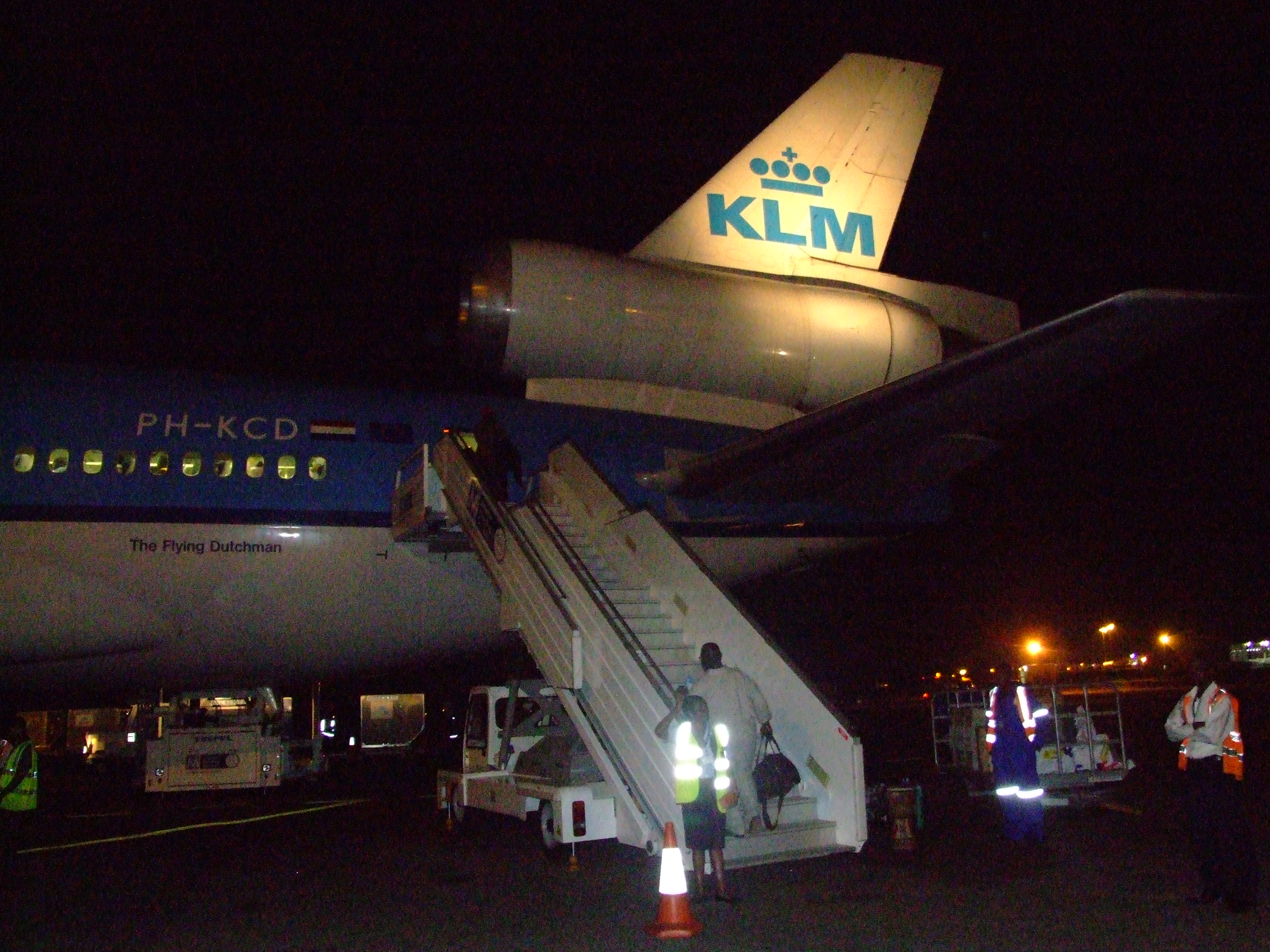 Rear door and illuminated tail of a KLM trijet at Accra airport