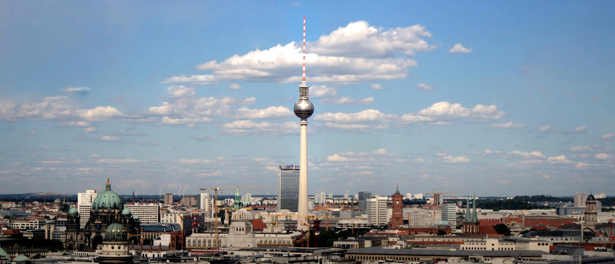 Panoramic view of the Berlin skyline with the Fernsehturm TV tower under a clear blue sky