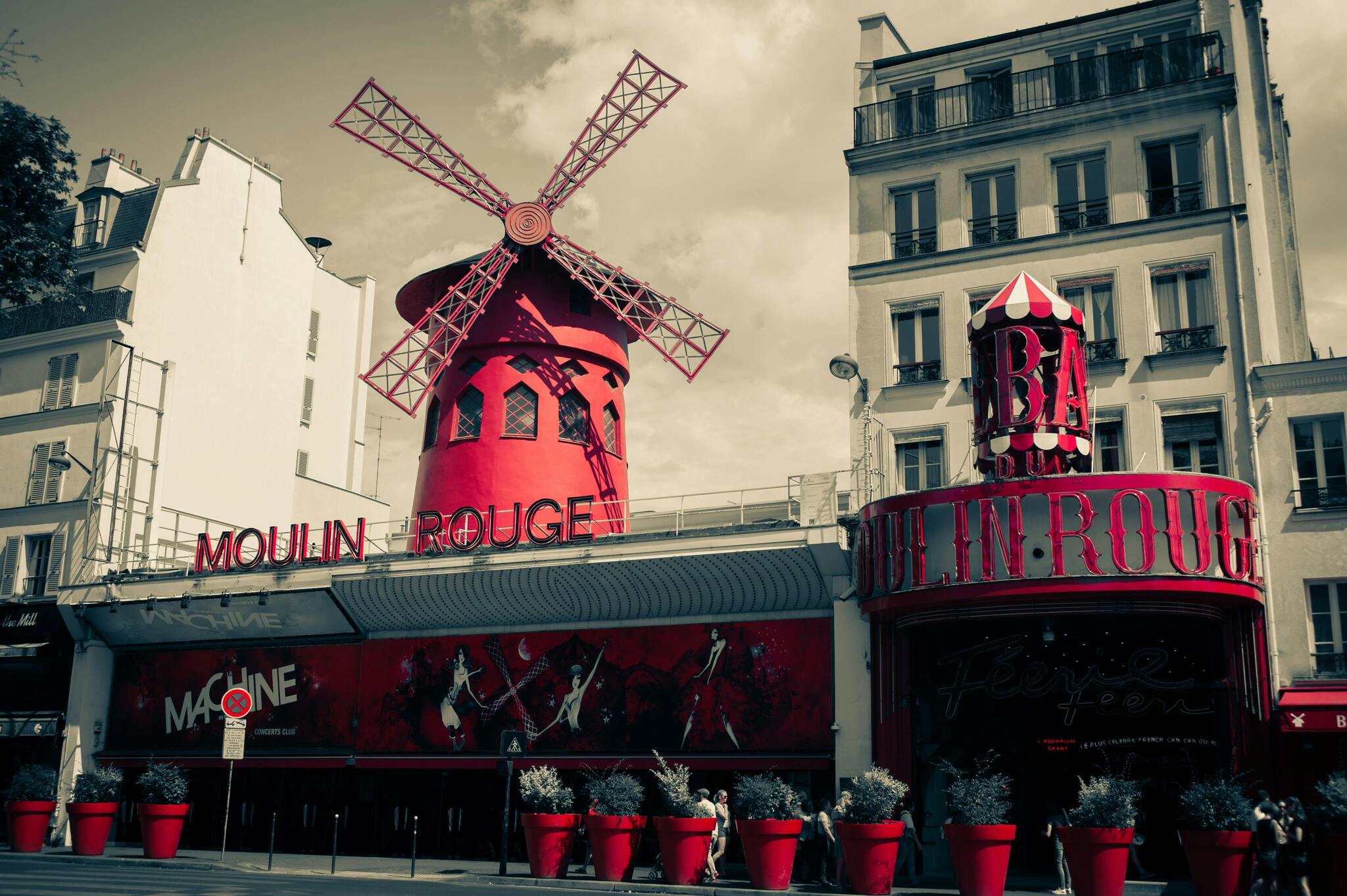 The red windmill and façade of the Moulin Rouge in Montmartre