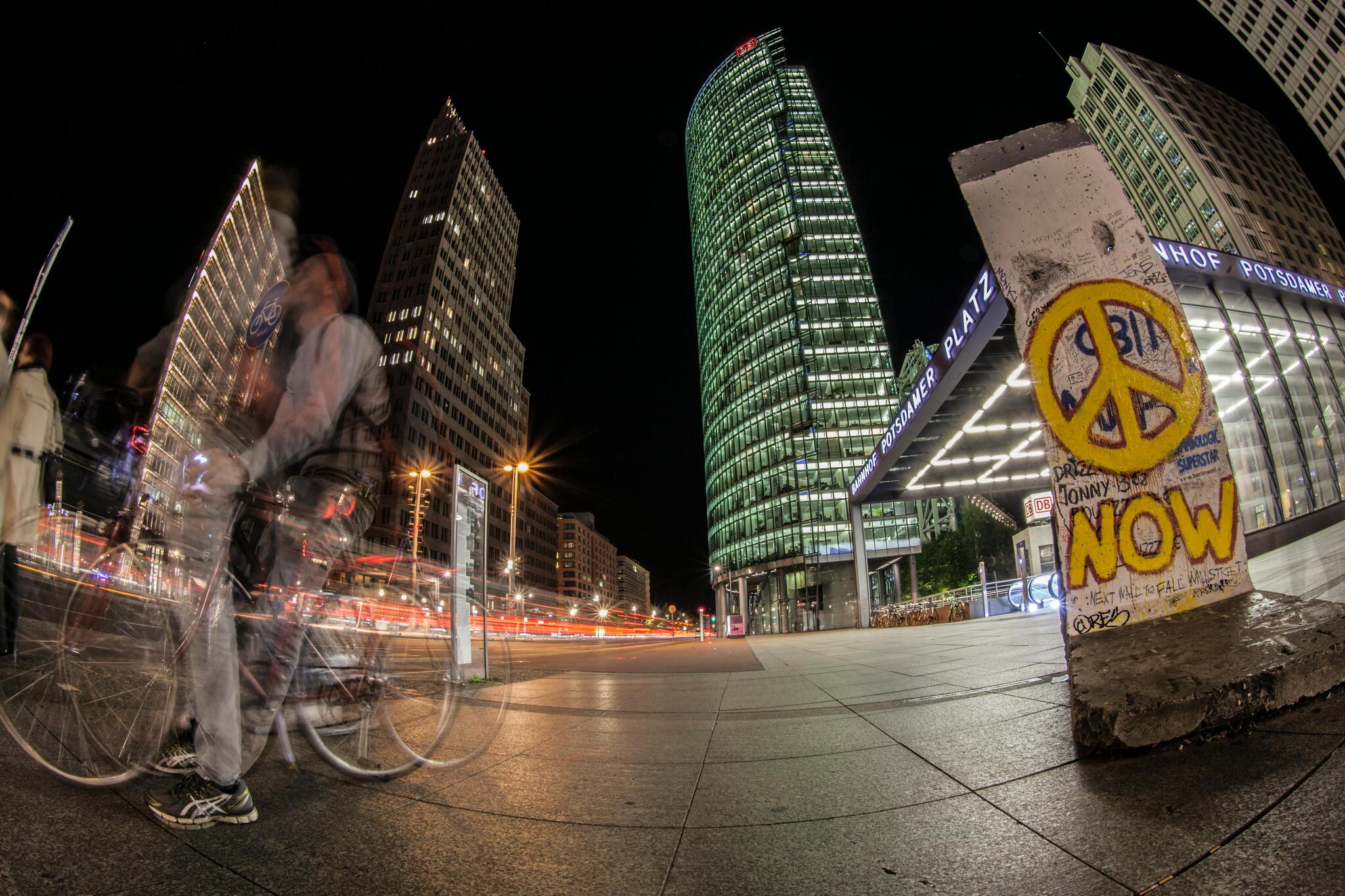 Potsdamer Platz at night with modern towers and light trails from traffic